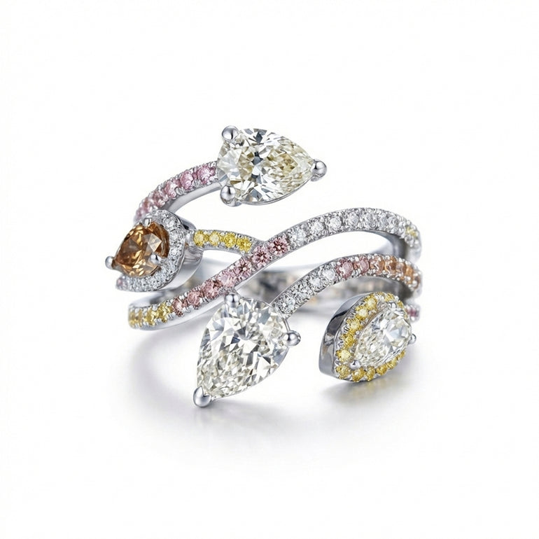 a bague Bagatelle en or 18 carats, présentant quatre diamants taille poire d'exception (dont un diamant brun) et un pavage dégradé de diamants roses, jaunes et blancs.